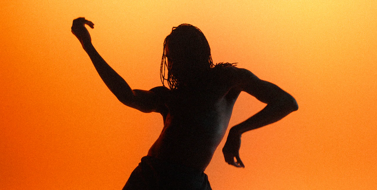 Endor campaign: a dancer in silhouette against orange