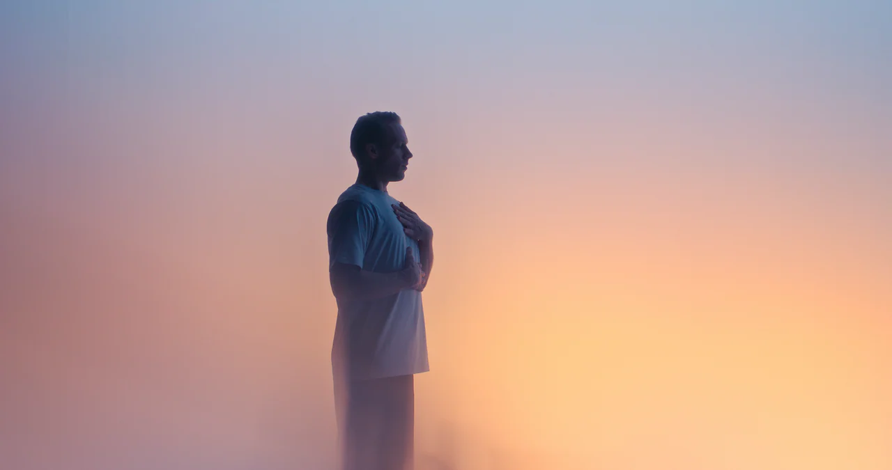 Endor campaign: a man with his hand on his chest in a warm gradient mist