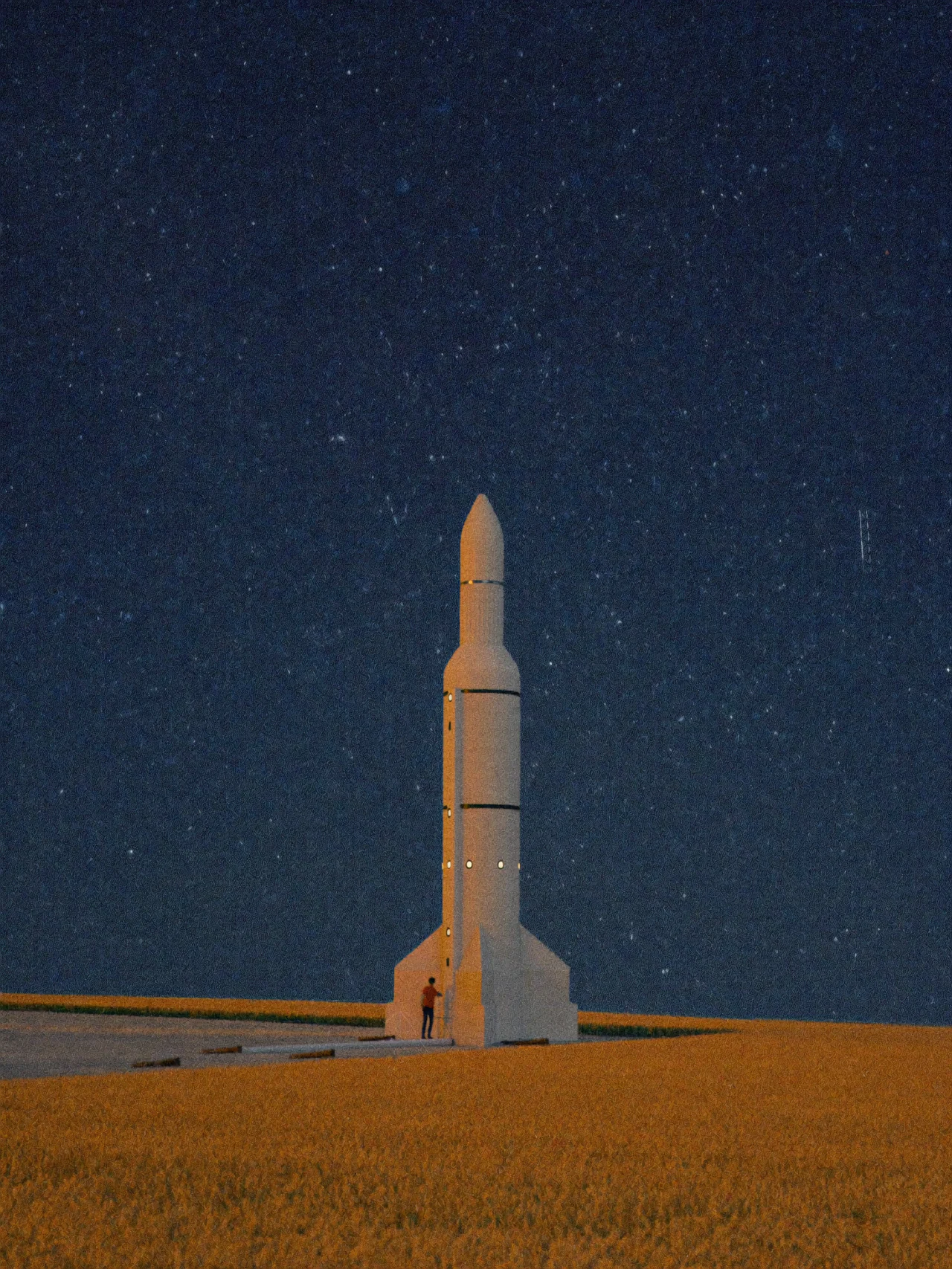A rocket standing in a wheat field at night