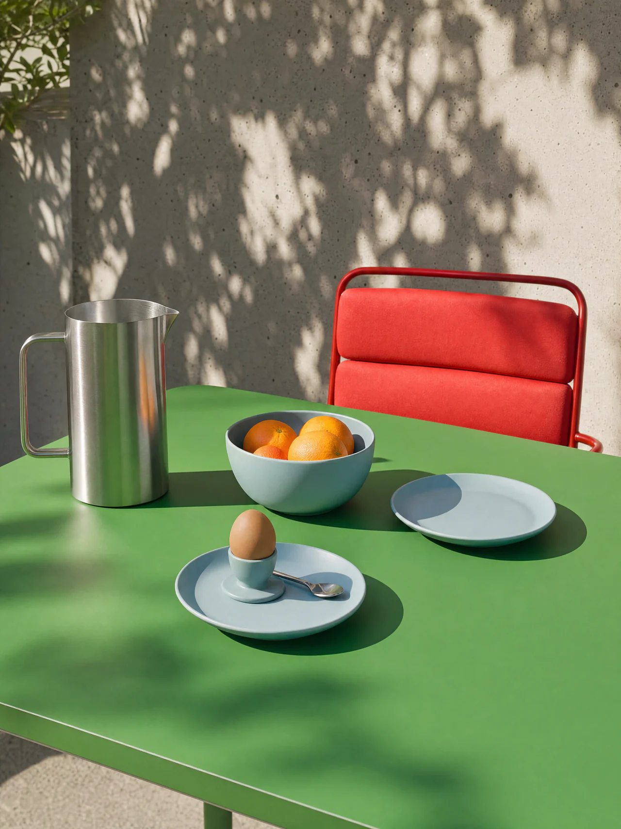 AI product image: green table and red chair in dappled light