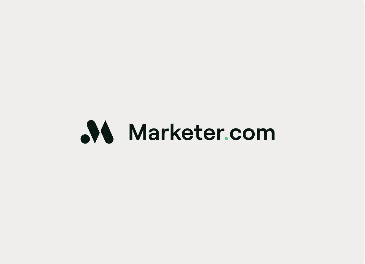 The Marketer.com lockup: the M symbol and the wordmark, with a mint dot in .com