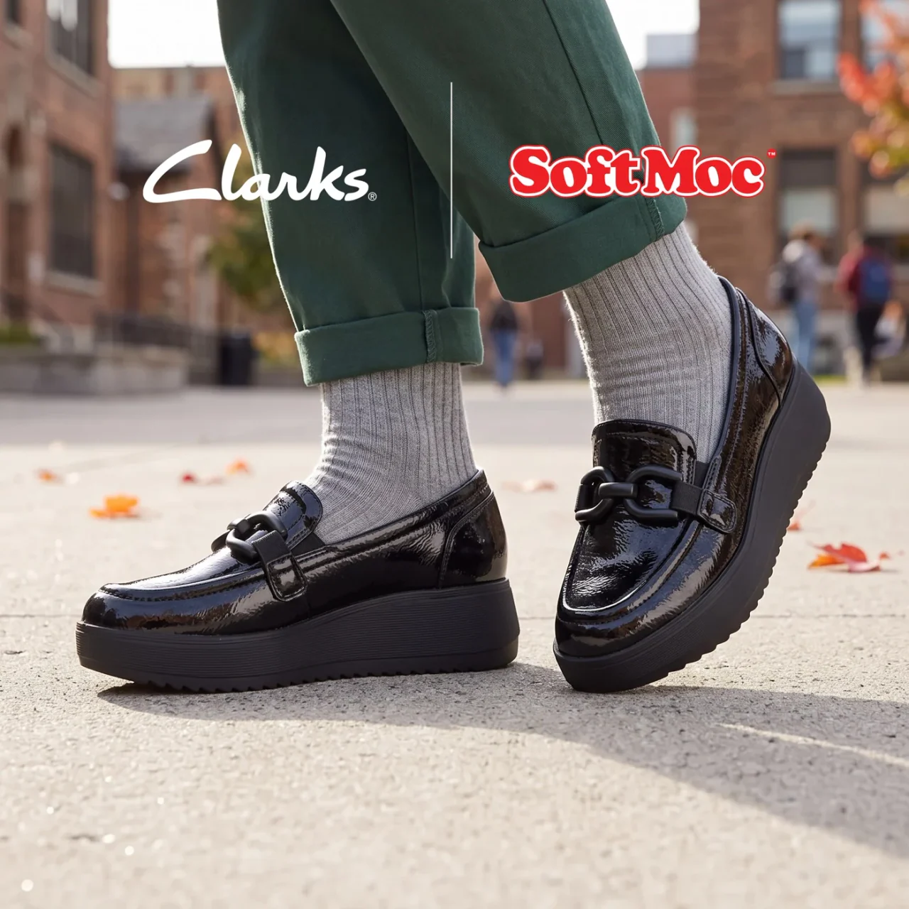 Black Clarks loafers worn with grey socks in a SoftMoc creative